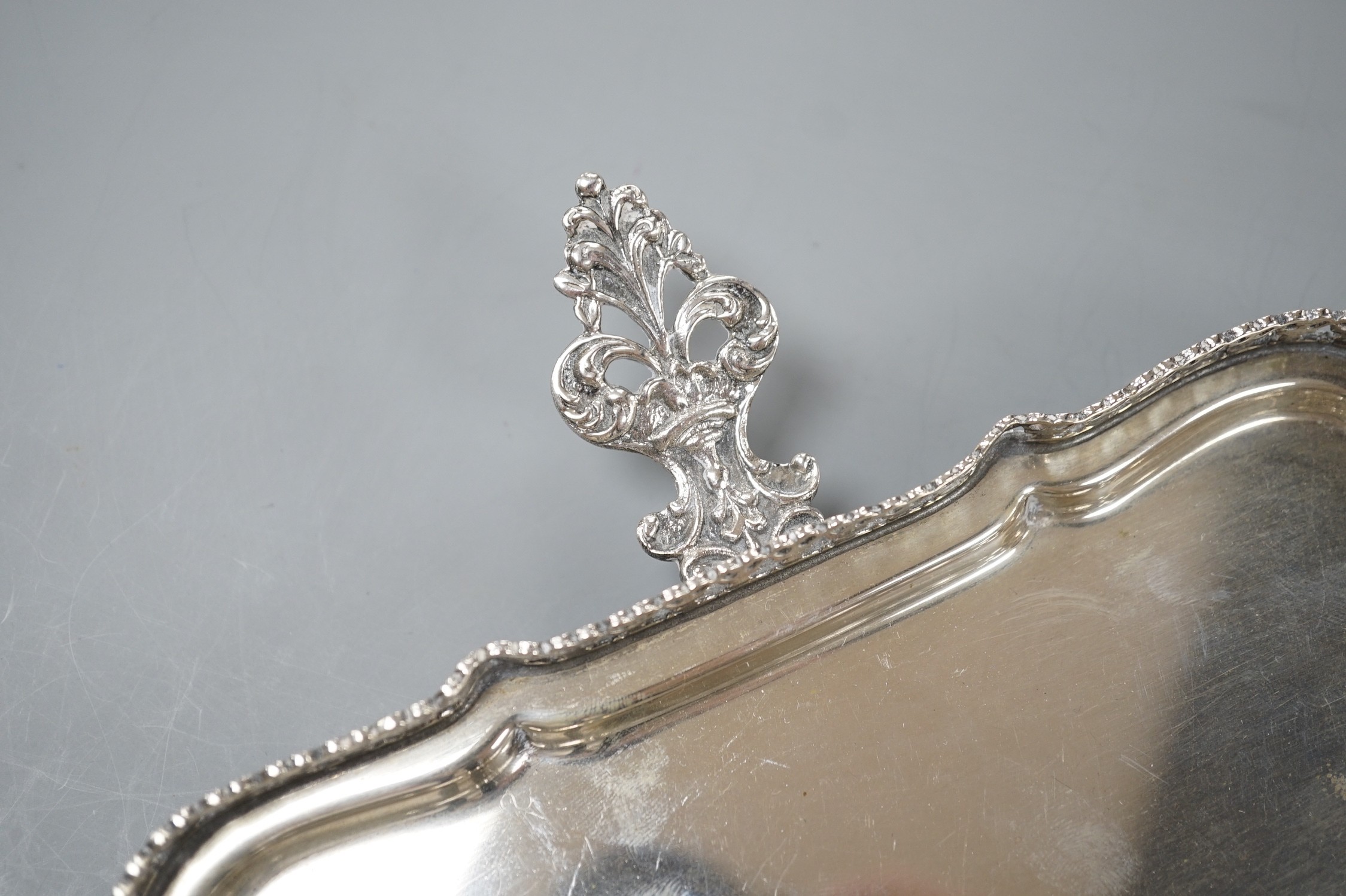 An engraved French white metal beaker, 81mm, a similar two handled shallow bowl by Risler and a modern Italian white metal snuffers stand, gross 13.5oz.
